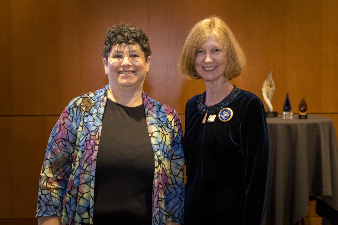 Two women stand next to each other.