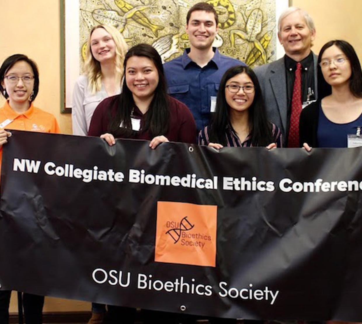 group photo of bio ethics team holding banner