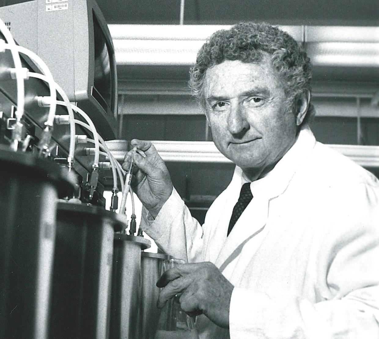 black and white photo of William Sandine working with lab equipment