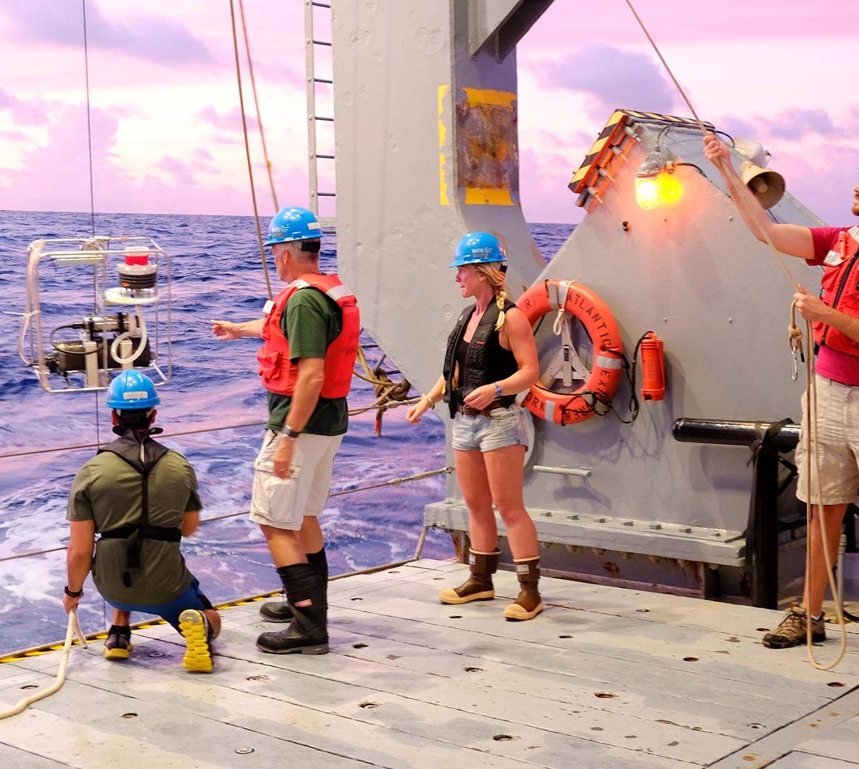 Researchers take a phytoplankton sample on an OSU research vessel.