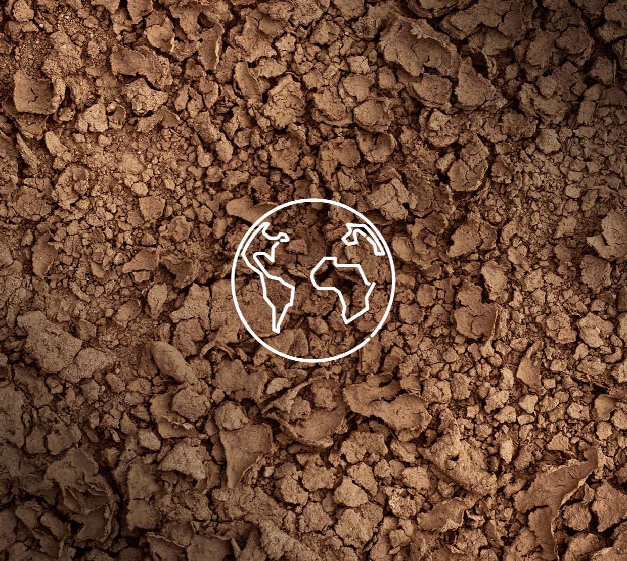 A background of brown soil with a white outline of earth. 
