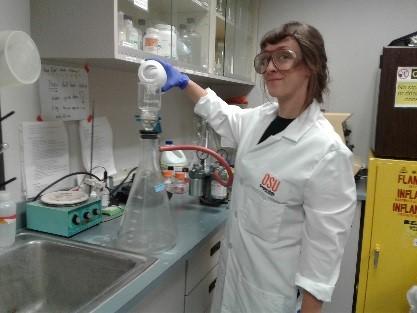 Microbiologist pouring water sample in vacuum pump.