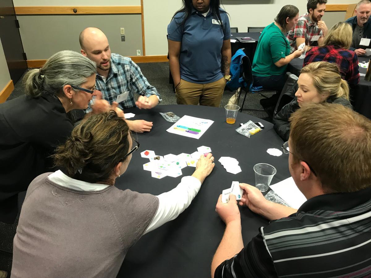 Oligotrophic board game being played by a group