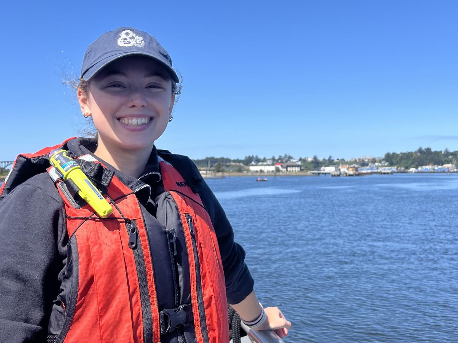 Courtney Clement standing at the rail of a boat.