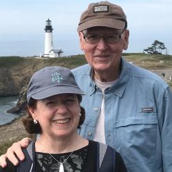 Ron and Ann Berg in front of Yaquina Head Lighthouse in Newport, OR