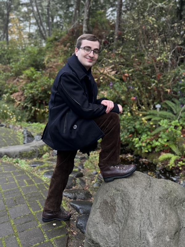 A photo of Elias posing on a nature path