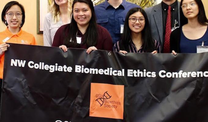 group photo of bio ethics team holding banner