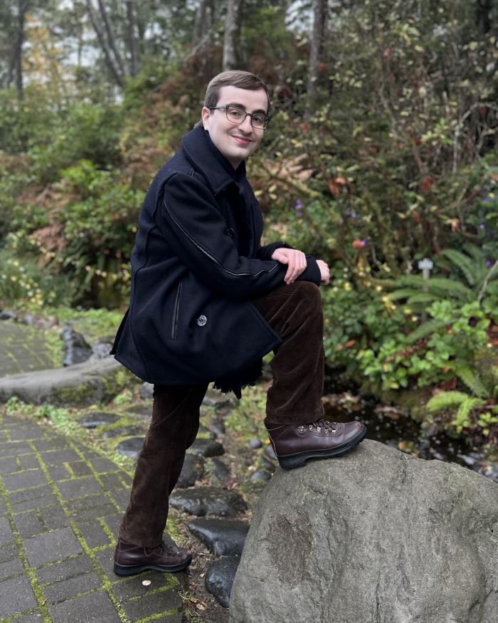 A photo of Elias posing on a nature path