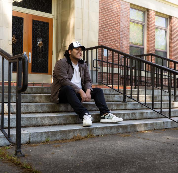 Bruno Salas Garcia sitting on the steps outside of Kidder Hall. 