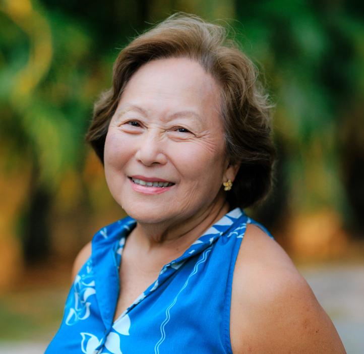 Jo-Ann Leong smiling on a beach in Hawaii